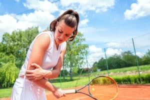 Woman experiencing pain from tennis elbow in Prescott Valley